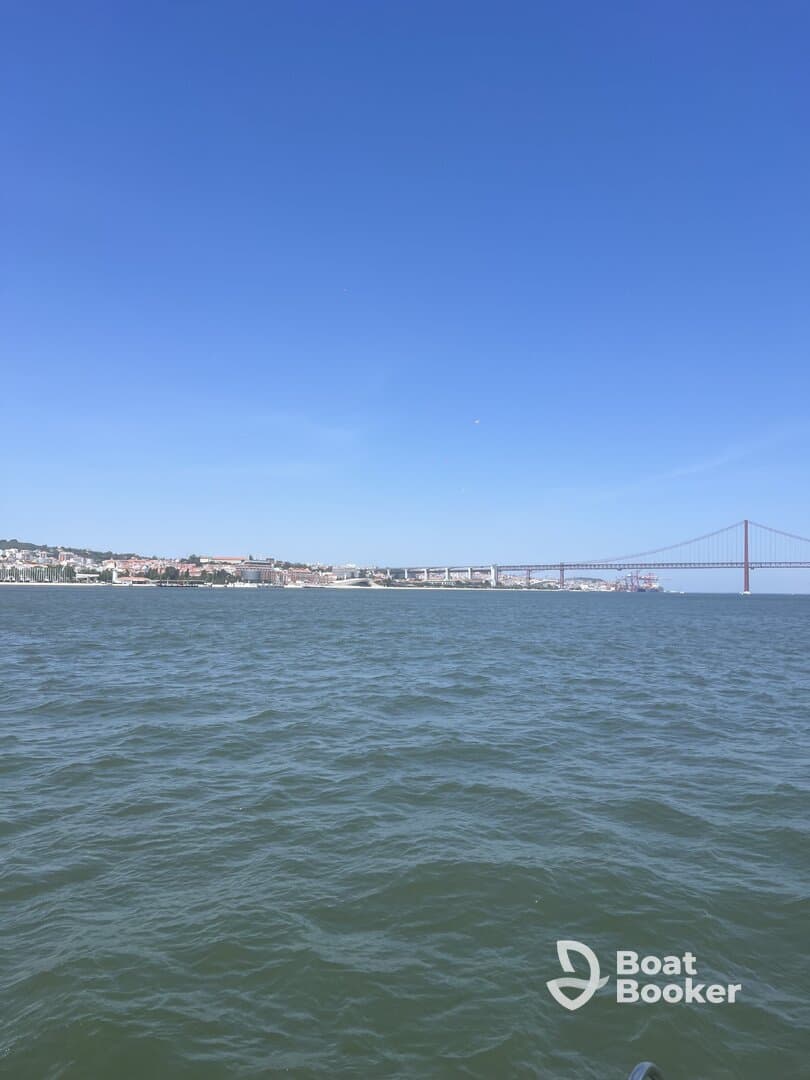 A picturesque view of the coastline and a bridge, showcasing the beauty of the waterfront — perfect for scenic boat tours and exploration.