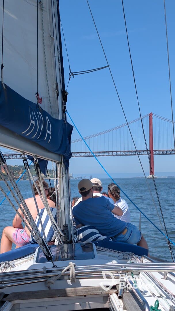 A group enjoys a scenic sailing experience with a stunning view of the bridge in the background, perfect for memorable outings on the water.