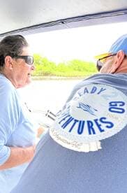 Two individuals enjoy a moment on a boat, showcasing the adventure spirit of a tour. Perfect for those seeking memorable experiences on the water.