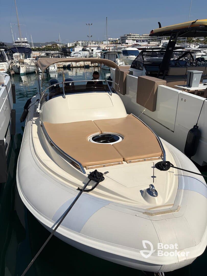 A sleek speedboat docked at the marina, showcasing its elegant design and inviting seating area — perfect for a day on the water.