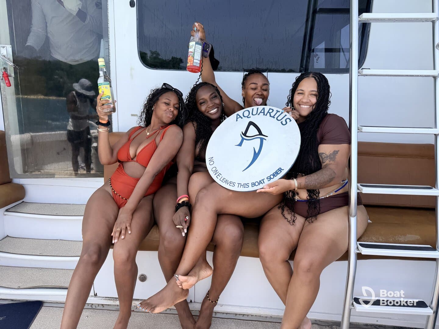 A lively group of friends enjoys a fun boat party, raising their drinks and celebrating together on the deck. Perfect for memorable outings and celebrations on the water.