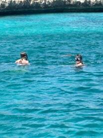 Two snorkelers explore the vibrant underwater world in crystal-clear waters, showcasing the excitement of aquatic adventures.