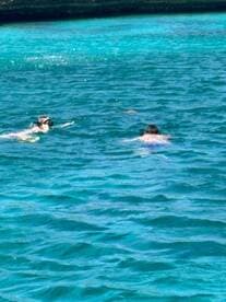 Two snorkelers explore the vibrant underwater world in crystal-clear waters, showcasing the excitement of aquatic adventures.