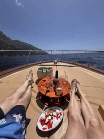 A relaxing moment on a boat featuring a delicious spread of dessert and drinks, perfect for enjoying the sun and sea.