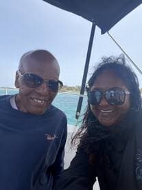 A joyful selfie of two individuals aboard a boat, capturing a memorable moment on the water — perfect for sharing experiences with friends and family.