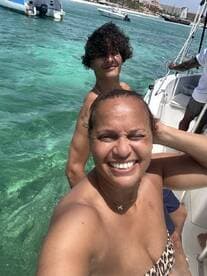 A joyful selfie captures two friends enjoying a sunny day on the water, showcasing the fun and excitement of their boating adventure.