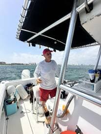 A captain stands at the helm of a boat, showcasing the interior setup with seating and equipment — perfect for a day on the water.