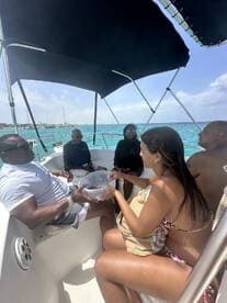 A lively group enjoys a meal aboard a boat, showcasing the perfect blend of relaxation and fun on the water.