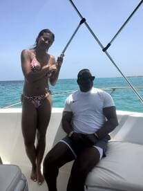 A couple enjoys a sunny day on a boat, capturing the essence of relaxation and fun on the water.