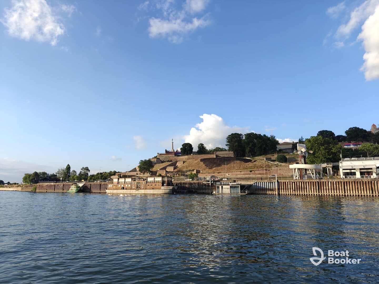 A picturesque view of a harbor with historical structures and lush greenery, perfect for exploring scenic waterways.