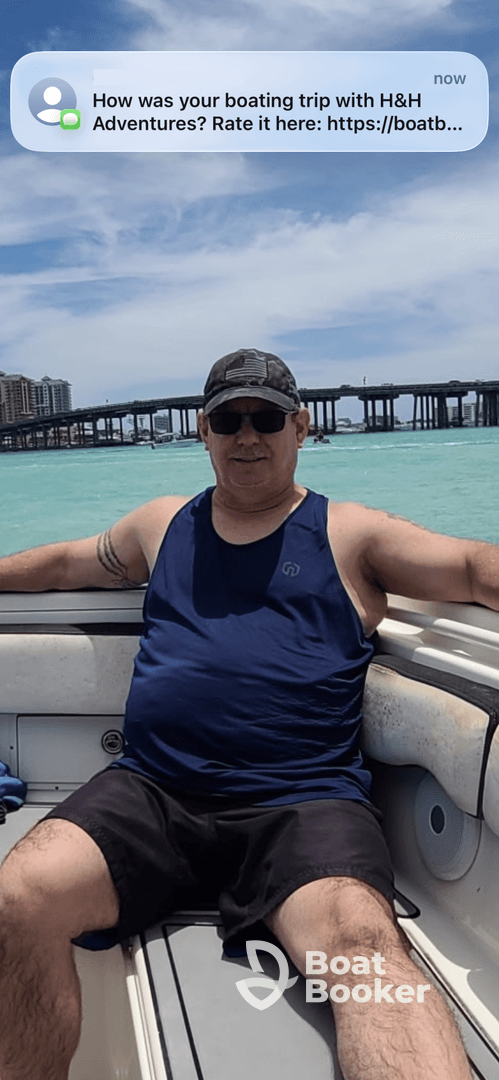 A man enjoys a relaxing moment on a boat, surrounded by beautiful turquoise waters — a perfect snapshot of a memorable boating trip.