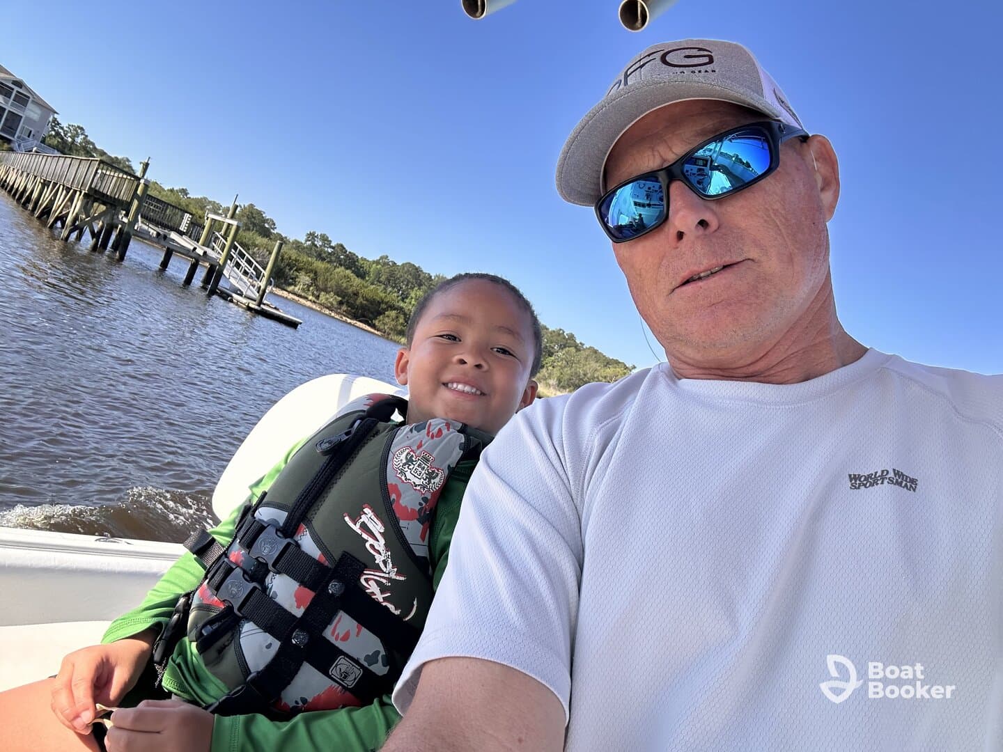 A joyful moment captured on a boat with a child and adult, showcasing a fun family outing on the water.