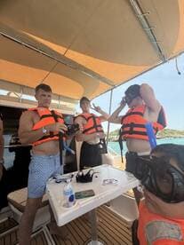 A group prepares for snorkeling on a boat, wearing life jackets and gearing up for an exciting underwater adventure.