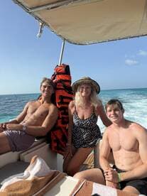 A cheerful family enjoys their time on a boat, capturing a moment of fun and relaxation on the water.