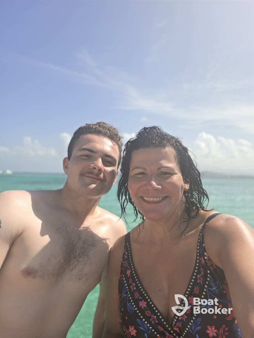 A joyful moment captured as a mother and son enjoy a swim in the beautiful turquoise waters, perfect for family bonding during a tropical getaway.