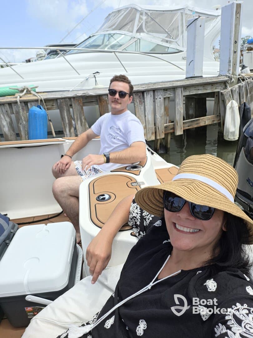 A couple enjoys a sunny day on a boat, capturing the essence of relaxation and friendship on the water.