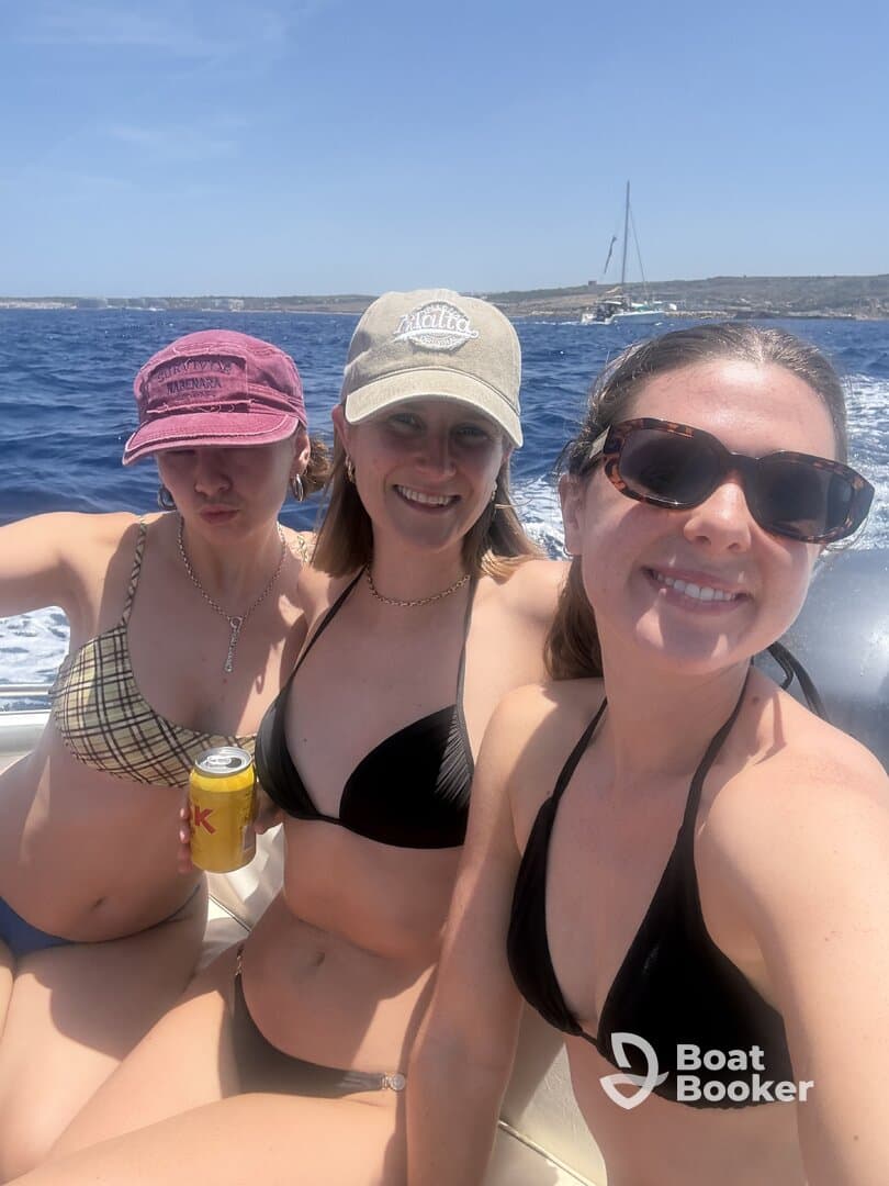 Three friends enjoy a sunny day on the water, capturing a fun moment aboard a boat — perfect for summer adventures and celebrations with friends.