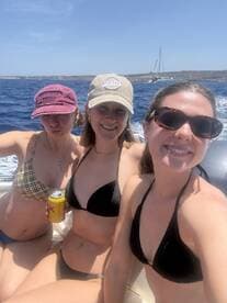 Three friends enjoy a sunny day on the water, capturing a fun moment aboard a boat — perfect for summer adventures and celebrations with friends.