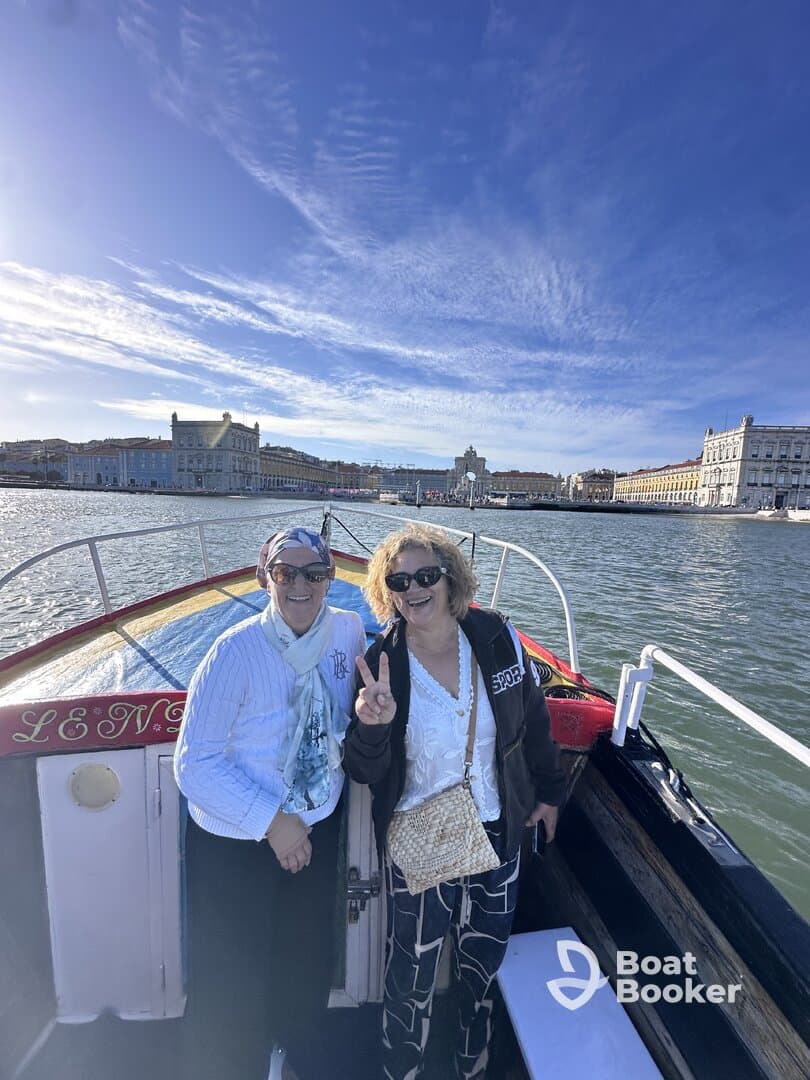 Two friends enjoy a joyful moment on a boat, capturing the essence of friendship and adventure on the water.