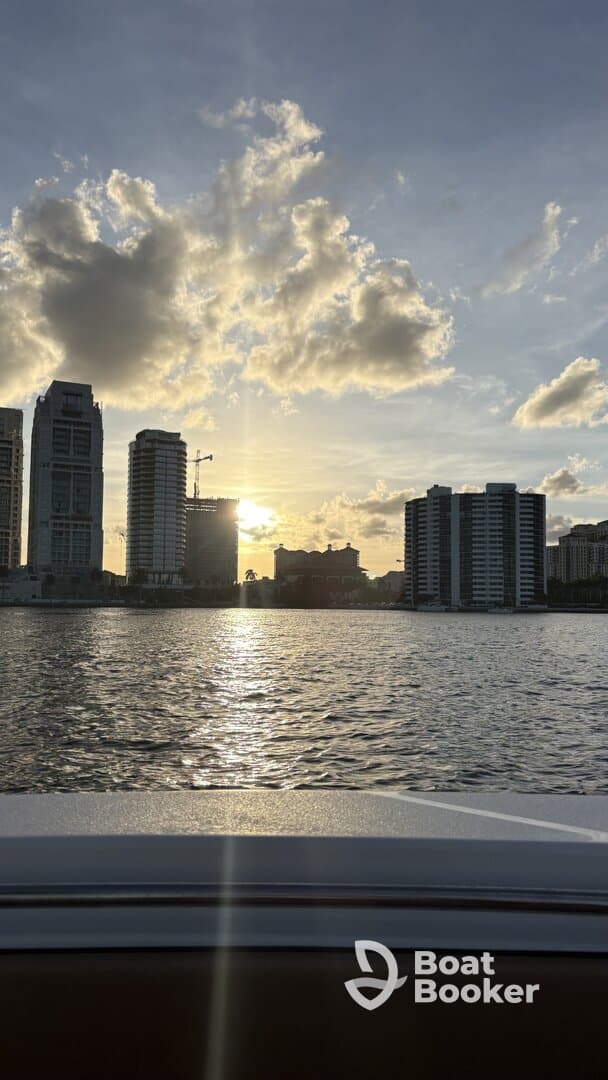 A stunning sunset view from a boat, showcasing the city skyline reflecting on the water — perfect for evening cruises and urban exploration.