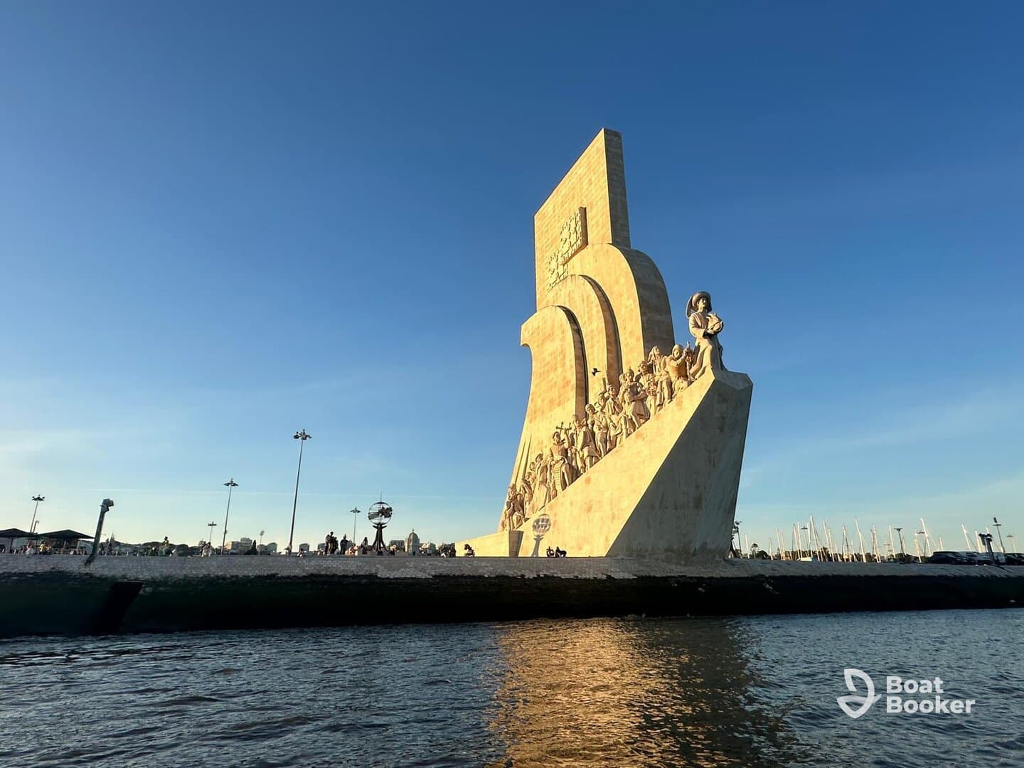 A stunning view of a prominent landmark along the waterfront, with people enjoying the scenic surroundings — perfect for sightseeing and cultural exploration.
