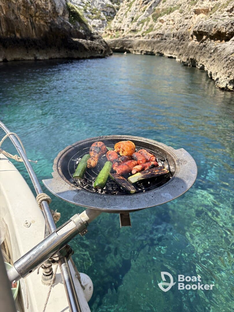 Delicious grilled sausages and zucchini sizzling on a boat's BBQ grill, perfect for a day of fun on the water.