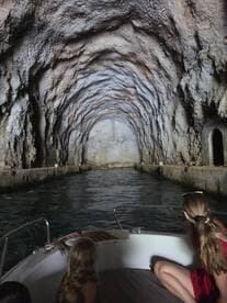 A family enjoys an adventurous boat ride through a stunning cave, creating unforgettable memories in a unique natural setting.