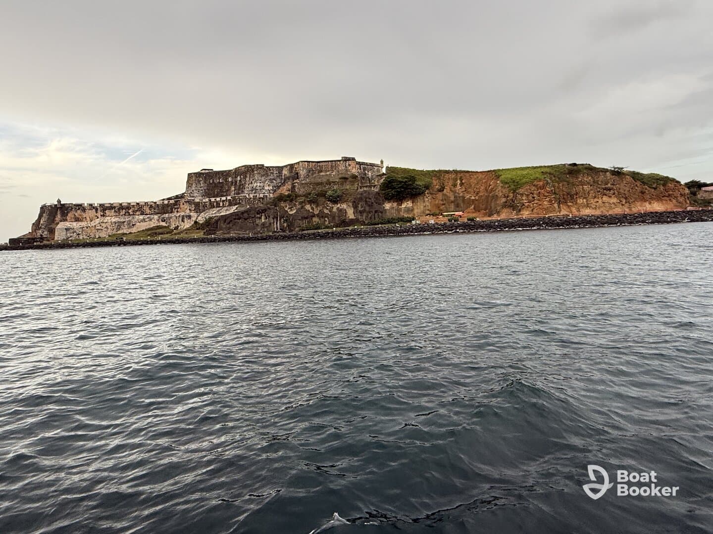 A scenic view of a historic coastal landmark, showcasing the rugged cliffs and tranquil waters — perfect for exploring by boat.
