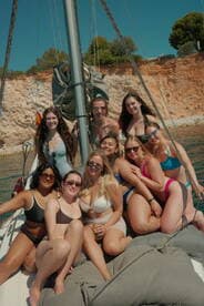 A lively group of friends enjoys a fun day sailing, capturing memories in the sun aboard a beautiful yacht. Perfect for celebrations and summer adventures on the water.