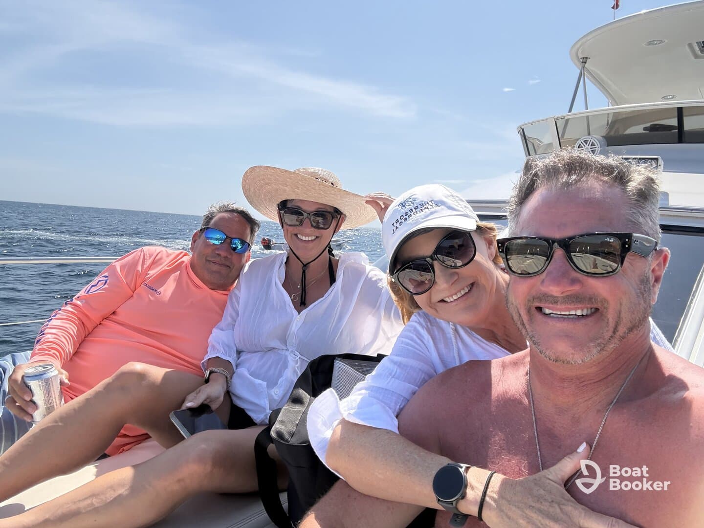 A cheerful group of friends enjoys a sunny day on the water, capturing memories aboard their boat. Perfect for showcasing fun outings and social gatherings on the sea.