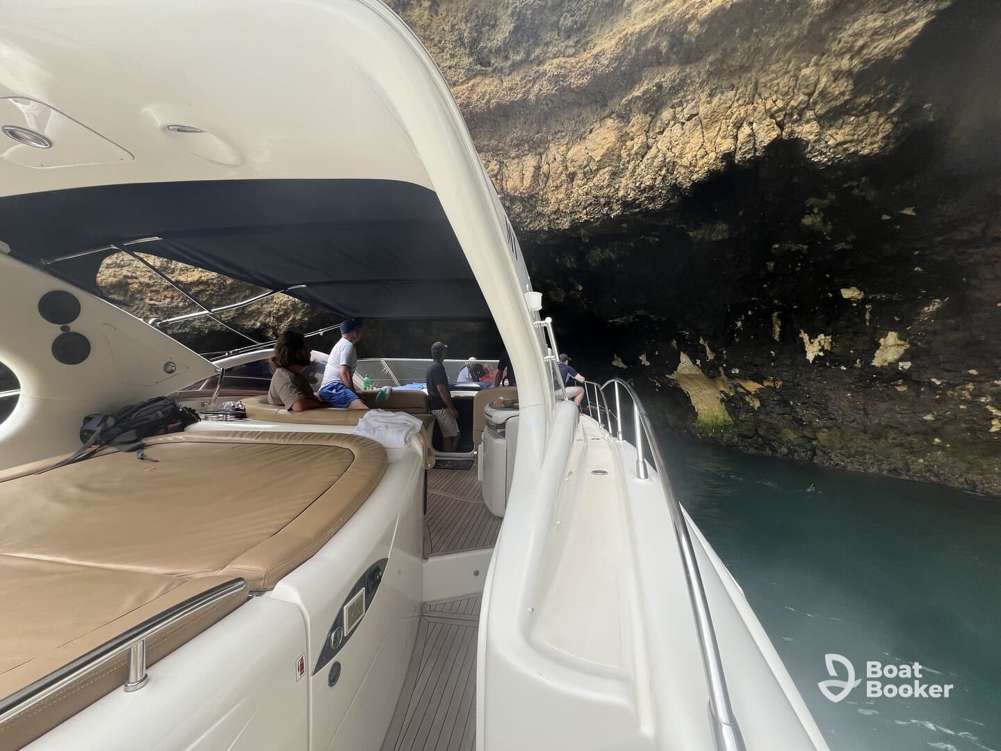 Guests enjoy a scenic boat ride exploring a cave, showcasing the adventure and beauty of the surroundings.