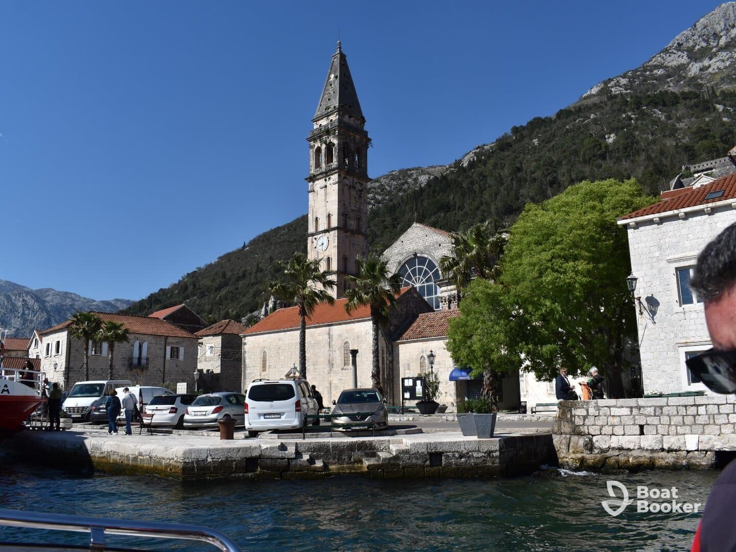 A picturesque view of a charming harbor with historical architecture and a clock tower, showcasing the vibrant atmosphere of coastal life.