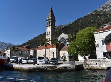 A picturesque view of a charming harbor with historical architecture and a clock tower, showcasing the vibrant atmosphere of coastal life.