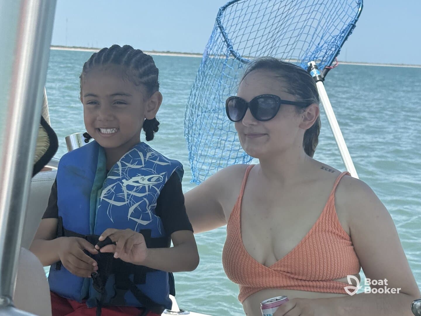 A joyful moment aboard a boat with a child wearing a life jacket and an adult enjoying the day on the water — perfect for family outings and adventures.