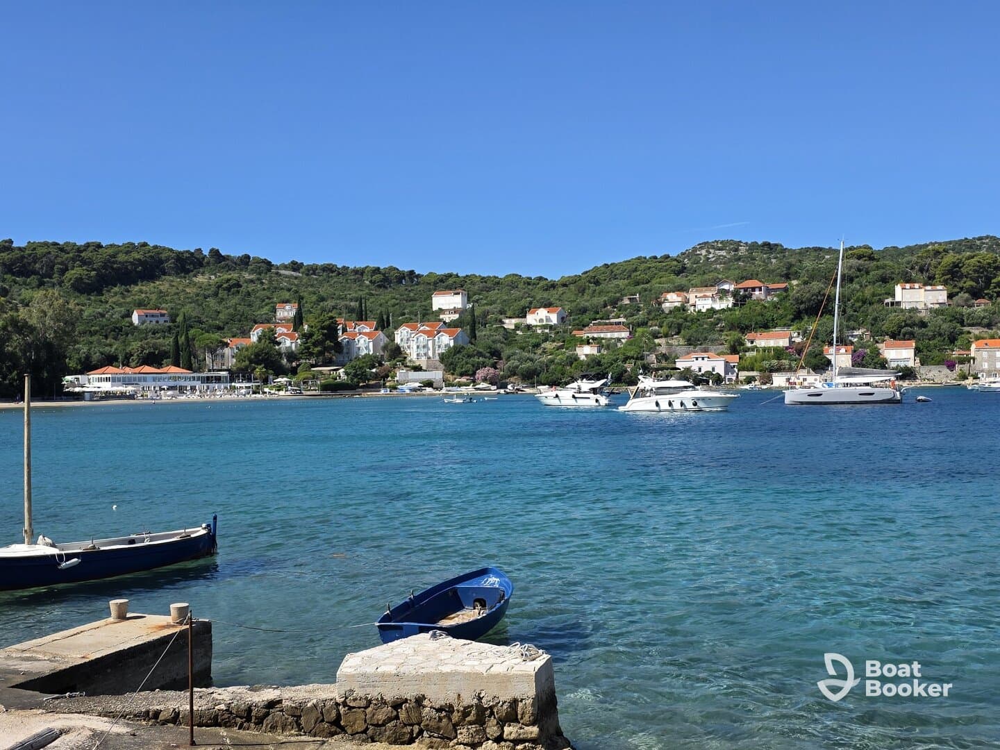 A picturesque view of a tranquil harbor with boats and charming coastal homes, perfect for showcasing the beauty of seaside destinations.