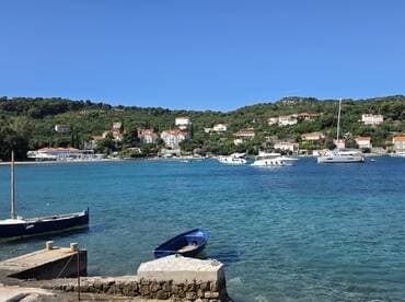 A picturesque view of a tranquil harbor with boats and charming coastal homes, perfect for showcasing the beauty of seaside destinations.