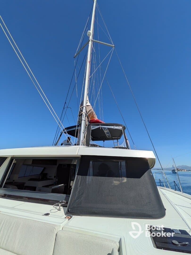 A stunning view of a yacht's mast and deck under a clear blue sky, showcasing the elegance of sailing adventures on the water.