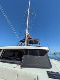 A stunning view of a yacht's mast and deck under a clear blue sky, showcasing the elegance of sailing adventures on the water.