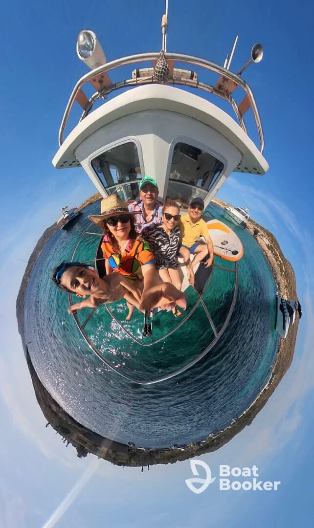 A joyful group of friends and family take a selfie on a boat, capturing their fun day out on the water — perfect for memorable boating adventures.
