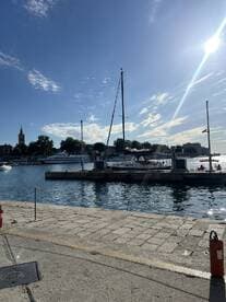 A serene view of sailboats docked in a harbor under a clear blue sky, perfect for showcasing the beauty of maritime life.