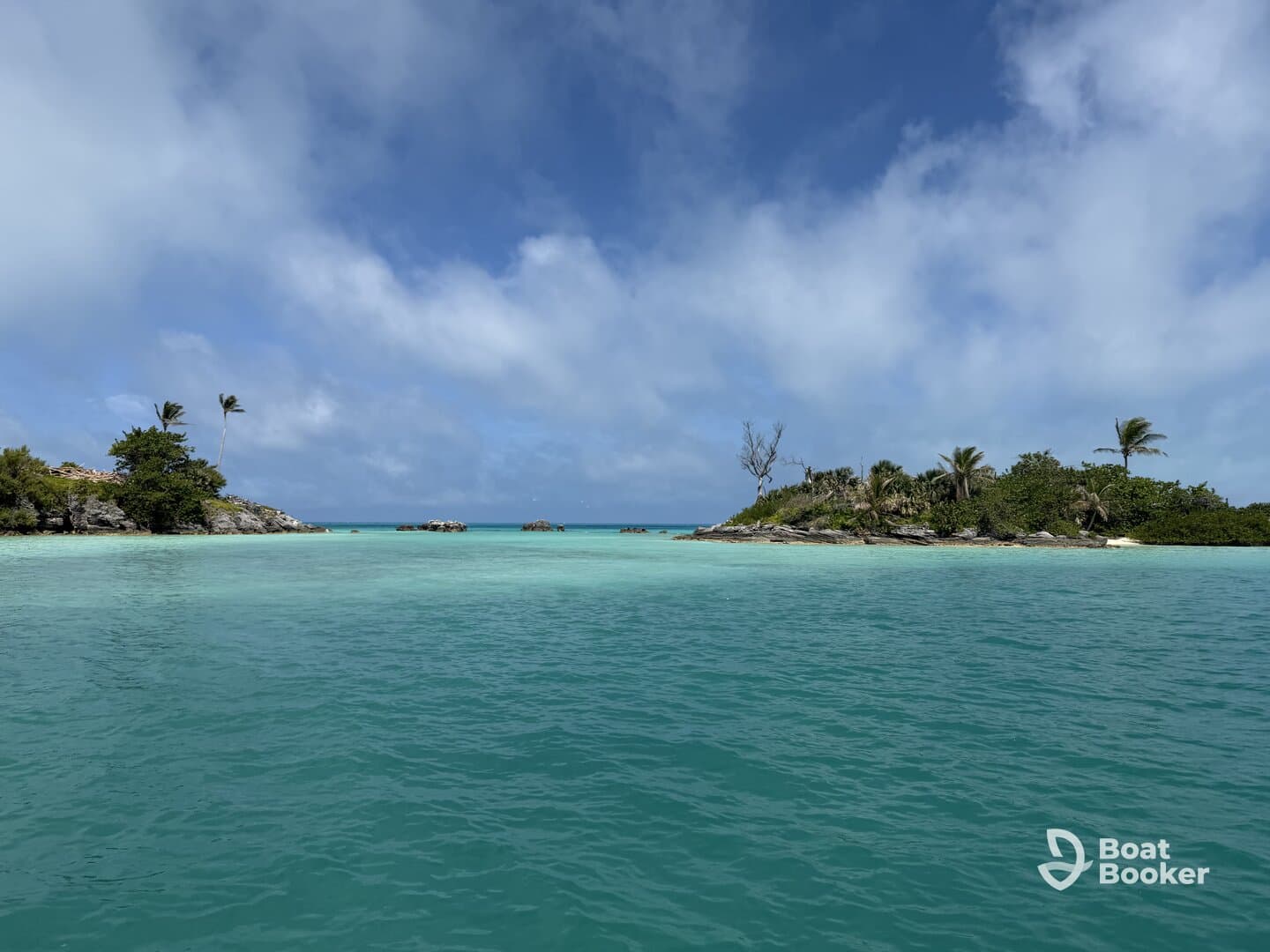 A stunning view of a tropical island surrounded by crystal-clear turquoise waters, perfect for island hopping adventures and scenic boat trips.