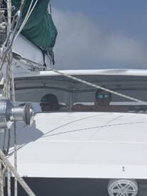 Two individuals relax in the helm of a boat, enjoying their time on the water. This captures the essence of a leisurely boating experience.