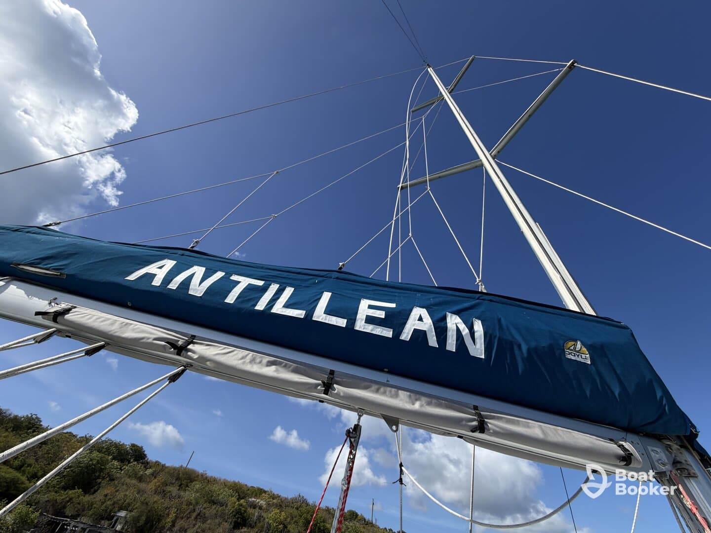 A close-up view of the sailboat 'Antillean' showcasing its mast against a vibrant blue sky, perfect for sailing enthusiasts and maritime photography.