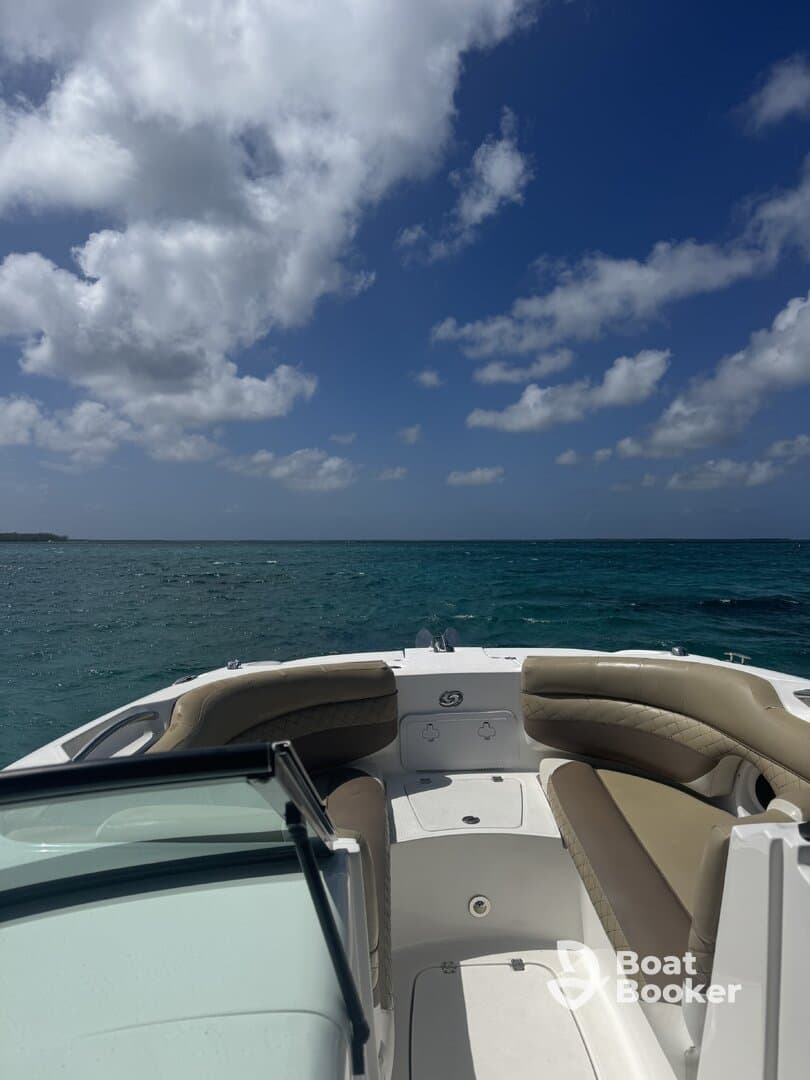 Interior view of a boat's seating area, showcasing a comfortable helm and spacious layout, perfect for relaxing while cruising on the water.