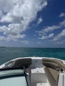 A view of the comfortable seating area inside a boat, showcasing a stylish helm and inviting atmosphere for a day on the water.