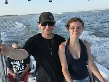 A young woman and a man enjoy a fun day on the water, showcasing the joy of boating with friends. Perfect for capturing memorable moments on the sea.