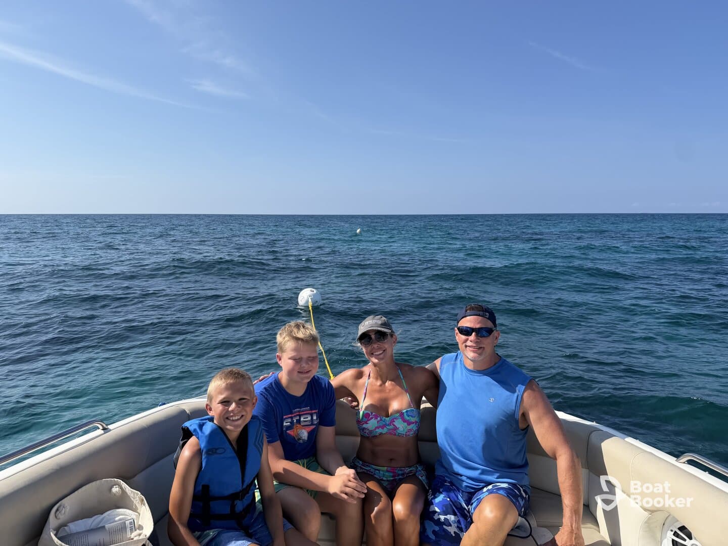 A joyful family enjoys a sunny day on the boat, creating lasting memories on the ocean — perfect for family outings and adventures.