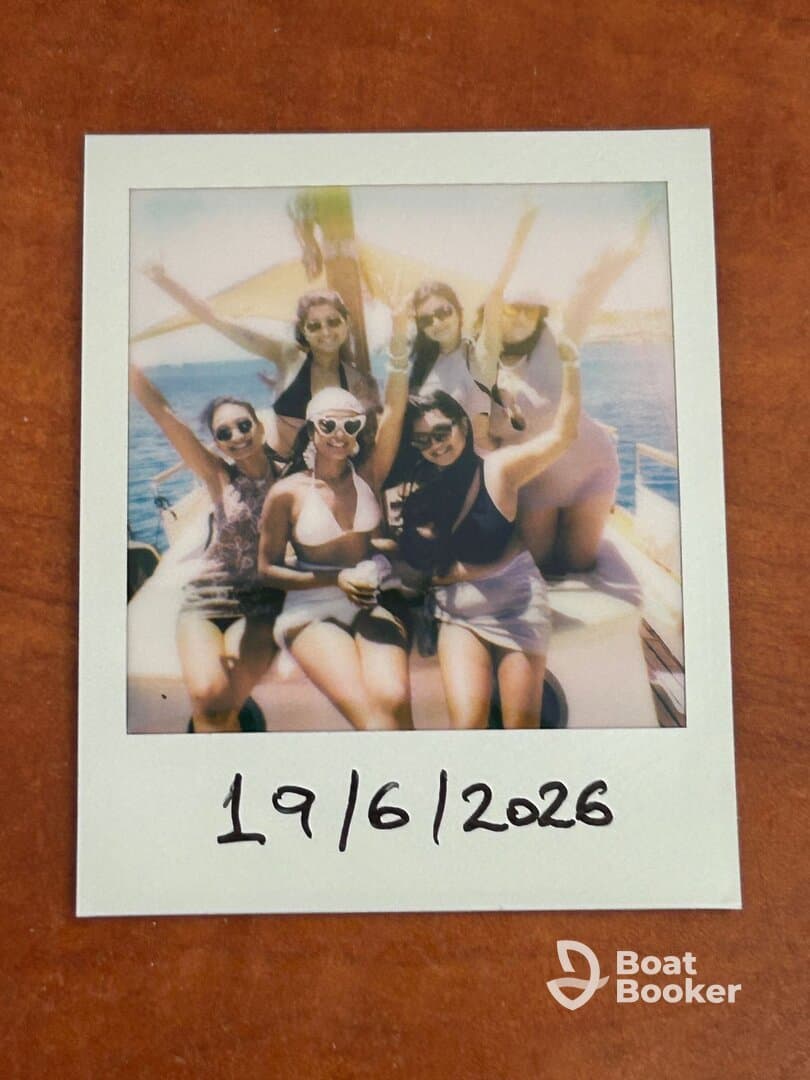 A joyful group of friends celebrates on a boat, capturing the fun of their day at sea — perfect for memorable outings and party adventures.