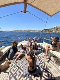 A lively group of friends enjoys a fun celebration aboard a boat, soaking up the sun and making memories on the water.