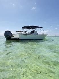 A sleek speedboat anchored in clear turquoise waters, perfect for a day of adventure on the water.